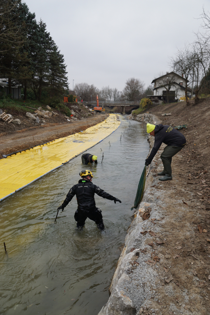 Pose de sacs de lestage fixés par mousquetons sur batardeau Water-Gate en courant au Mali Graben